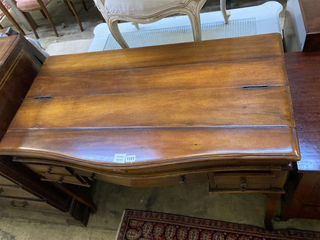 A reproduction mahogany serpentine front writing table, width 106cm depth 57cm height 84cm